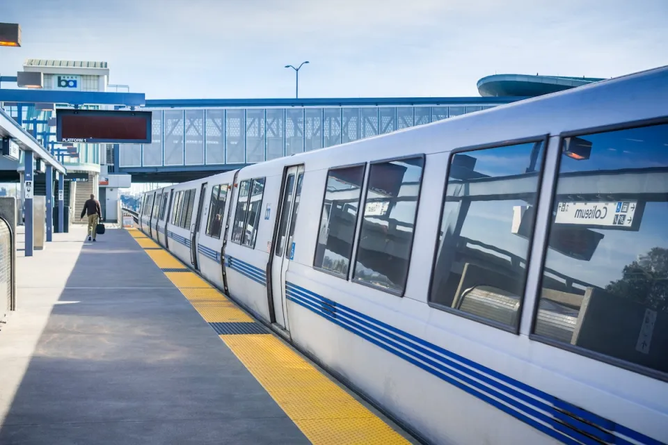 White BART public transit train at Coliseum station in Oakland, California.